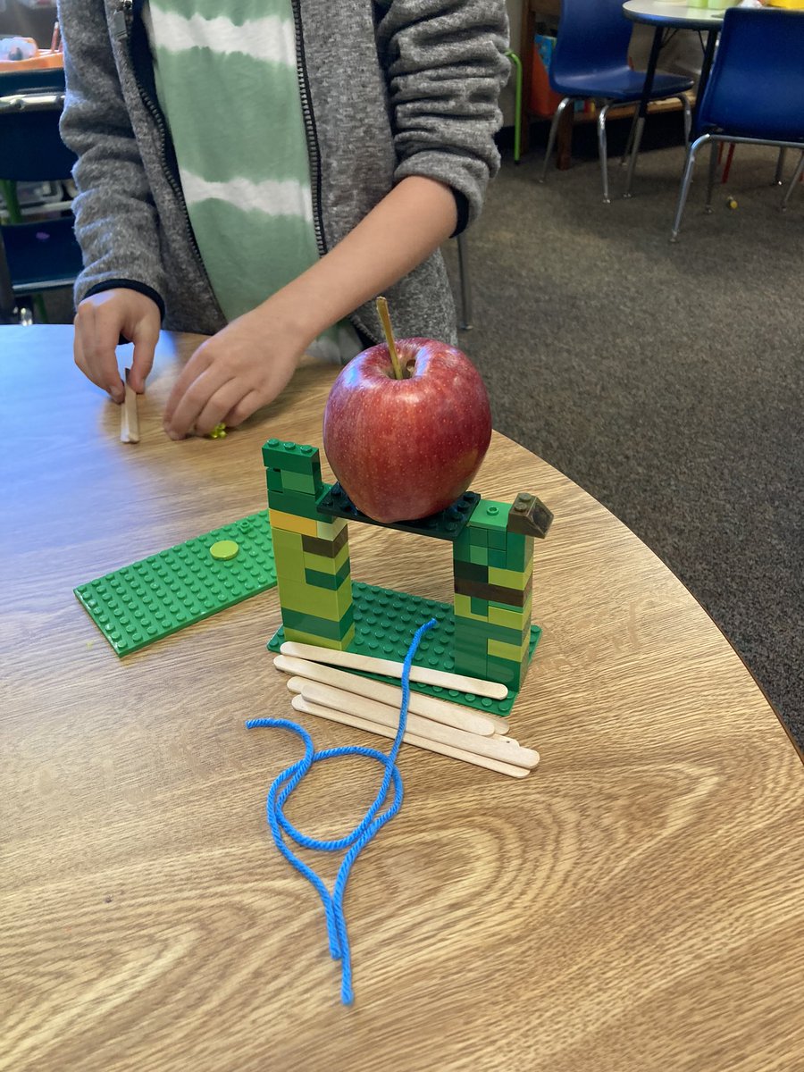 BardonBann's tweet photo. STEAM is so fun with 1st grade Ss! 1st grade learning how to collaborate in a small group building a bridge strong enough to hold an apple using legos, strings and popsicle sticks @BriarcliffES https://t.co/DcvBlNXGC3