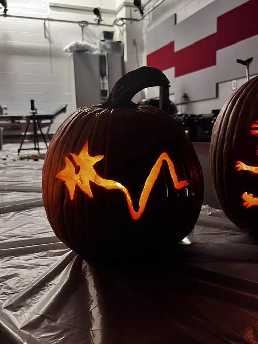Pumpkin with the NRL logo of a neuron and propulsion curve carved into it