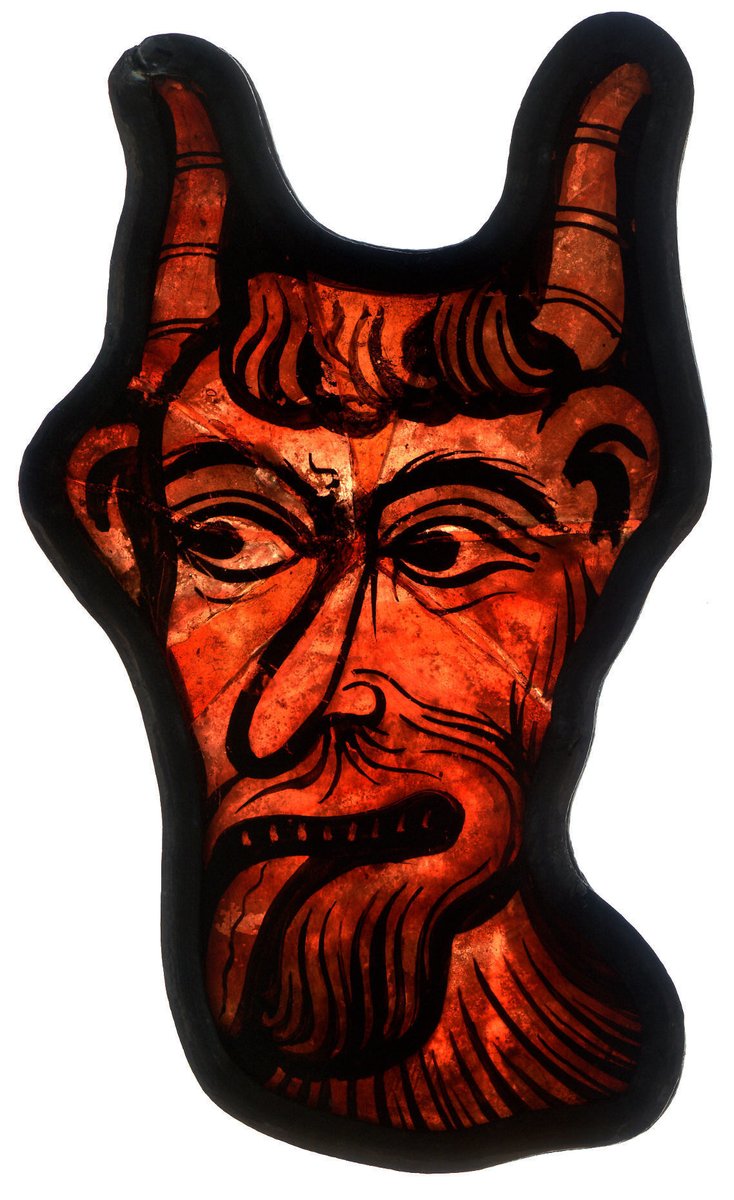 Fragmentary stained glass devil, made in France, 1200-15. The devil is from the destroyed ambulatory windows of the Cathedral of Saint-Etienne in Bourges, and was probably part of a Last Judgment scene. Collection: The Met.