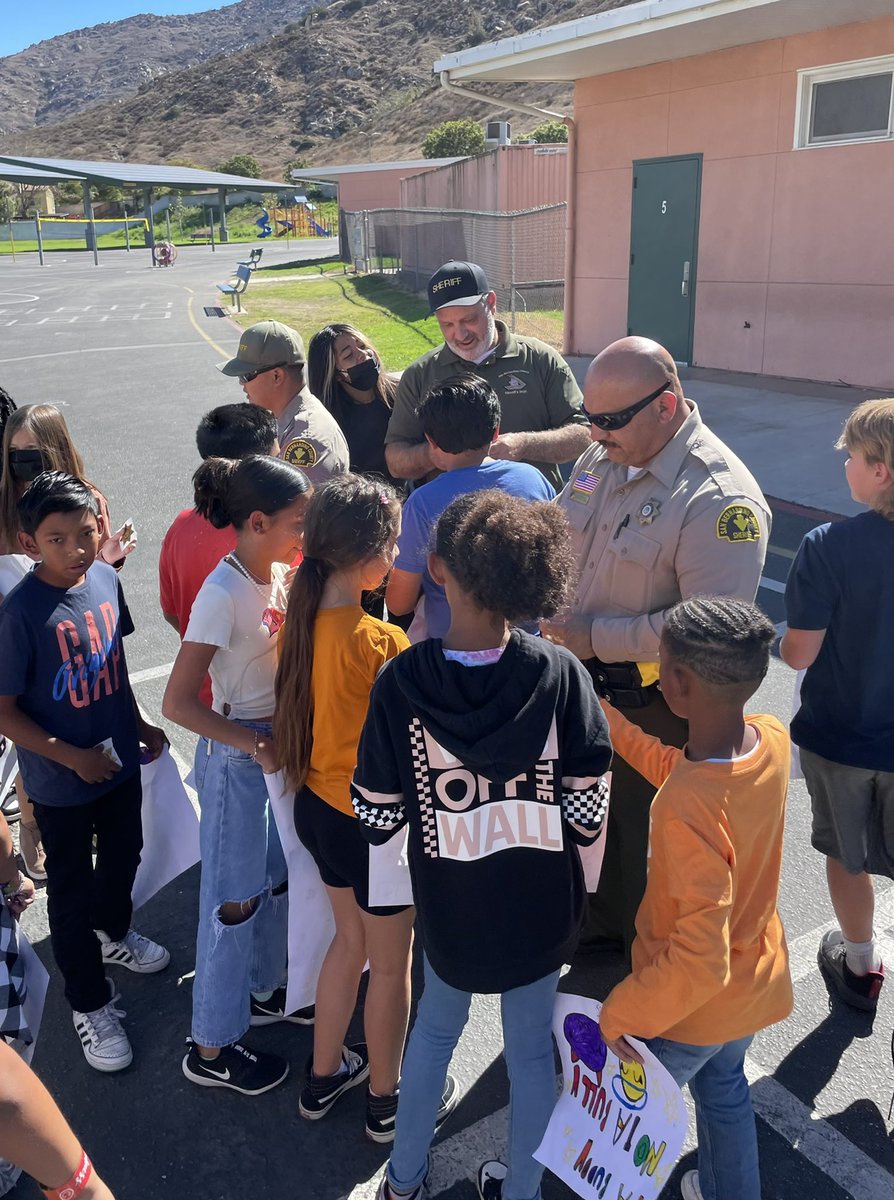 CJUSDSafety's tweet photo. @fontanastation #SRO/Deputy Dominguez brought backup to help spread messages of #kindness @JVRoadrunners. #Students were even sworn in as #JuniorDeputies before taking a group picture at today’s #UnityDay22 celebrations. #KindnessBus #BullyingPrevention #SBCSD #cjusdS3 https://t.co/qVejgAnrPj