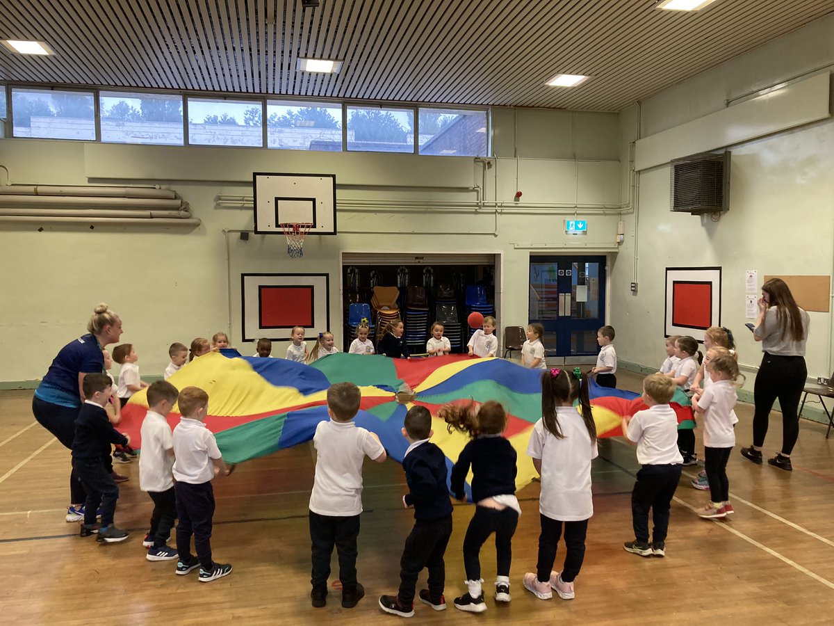 SJBPS11's tweet photo. Coach Anna from @MaloneCollege has been leading the P1 children through parachute games this morning as part of our Fitness Fun Day. #SJB https://t.co/P1OsTSLUMk