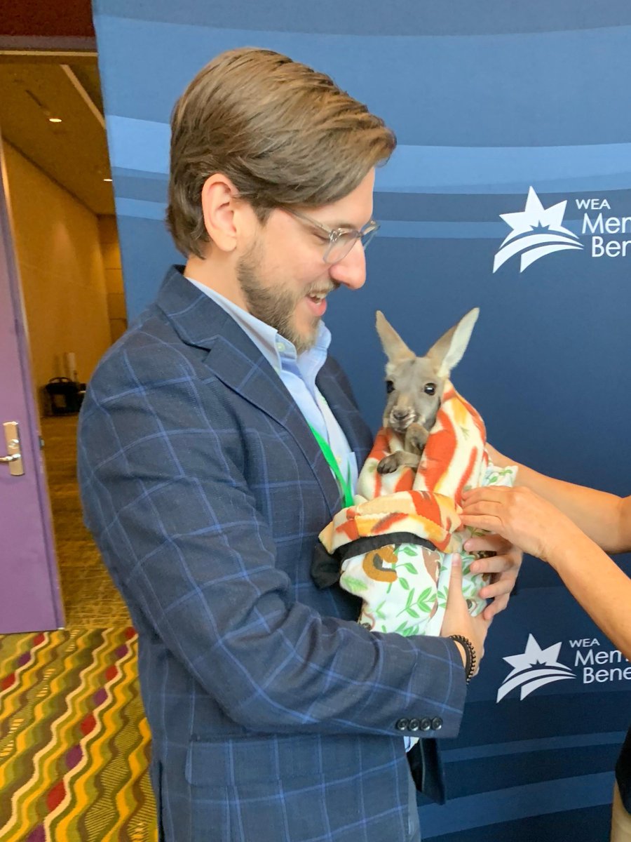 CSGSouth's tweet photo. Policy analyst @Cody_CSGSouth JUMPED at the chance to hold this joey! 
Thanks to @WildKingdom for providing this exhibition during  @nrea1 
#ruraledforum #ruraleducation #partnerships https://t.co/QftNO4qzxx