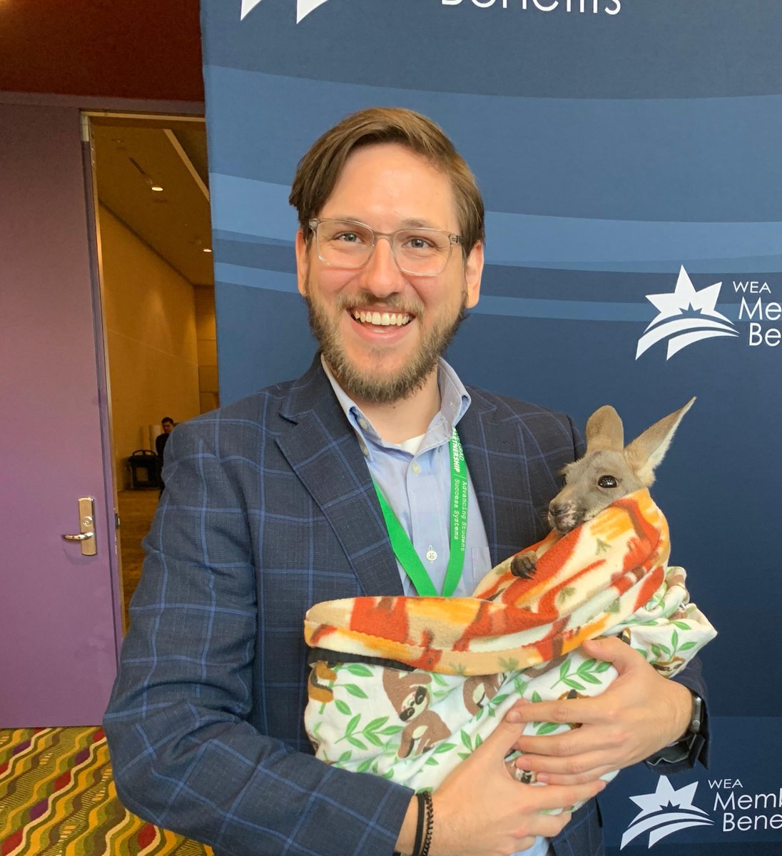 CSGSouth's tweet photo. Policy analyst @Cody_CSGSouth JUMPED at the chance to hold this joey! 
Thanks to @WildKingdom for providing this exhibition during  @nrea1 
#ruraledforum #ruraleducation #partnerships https://t.co/QftNO4qzxx