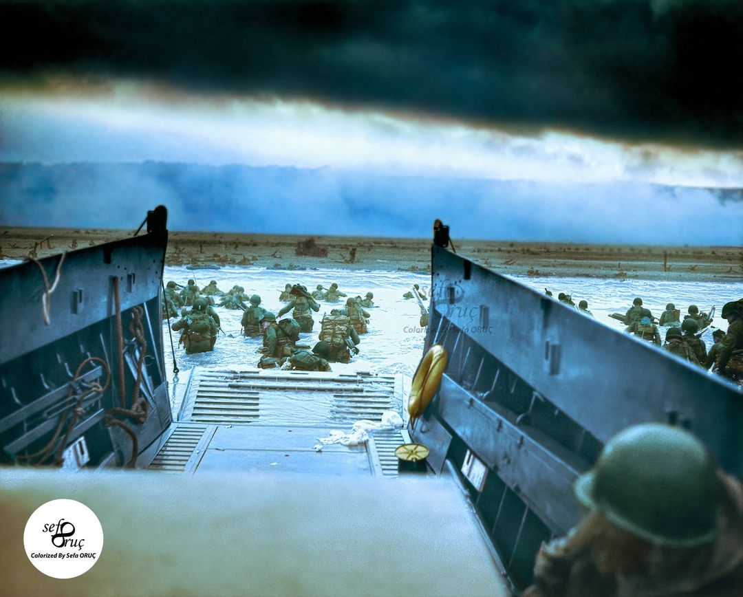 One of the most iconic photos taken during WW2, “Taxis to Hell – and Back – Into the Jaws of Death” shows the US Army's 1st Infantry Division soldiers disembarking from an LCVP from the US Coast Guard-crewed USS Samuel Chase at Omaha Beach on 6 June 1944. 

Credit: <a href="/orucsefa19/">socolorization</a>