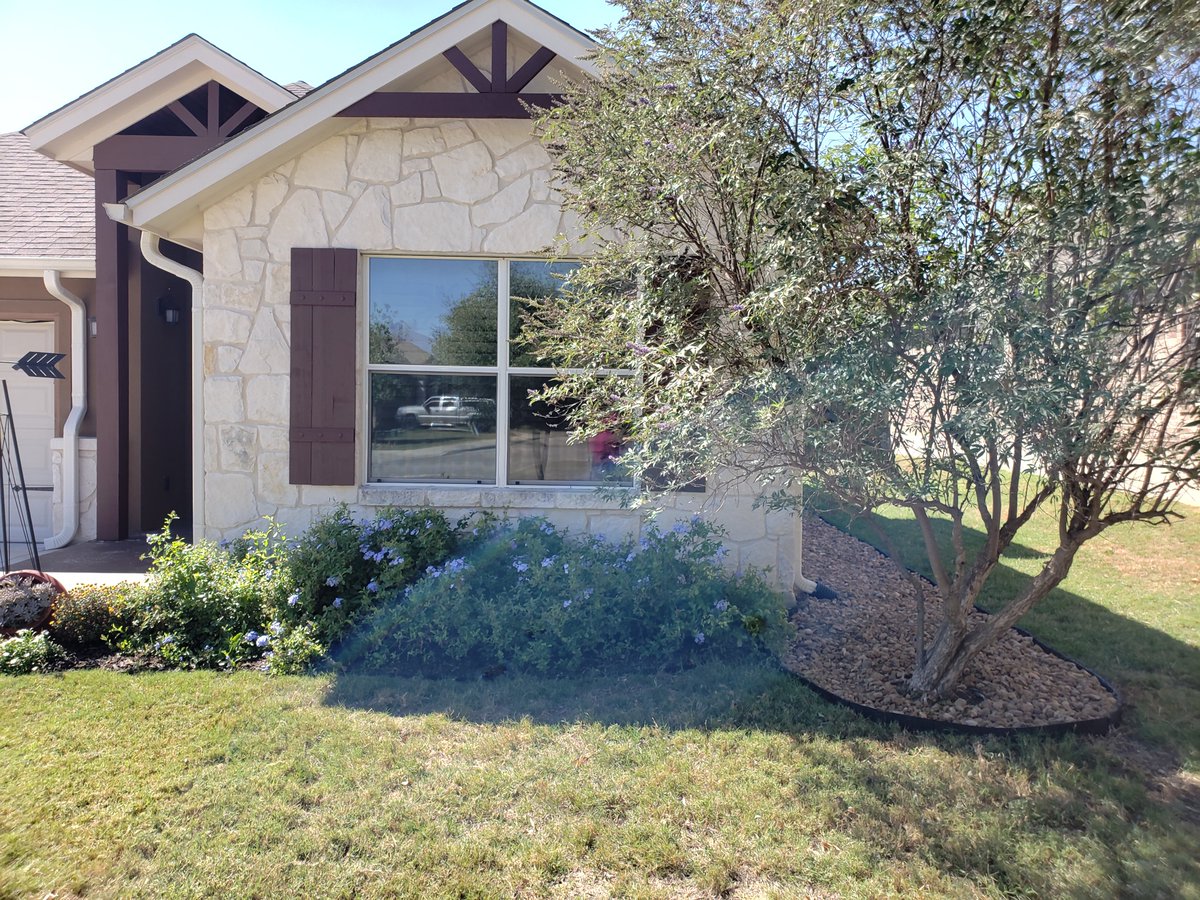 We had a French drain put in to help with some pooling water. Our contractor did a lousy job, and left the rocks unfinished. Just a bunch of rocks plopped down. 
So I put in some nice rubberized edging to make it looks better. Finished that up today and am pretty happy with it.
