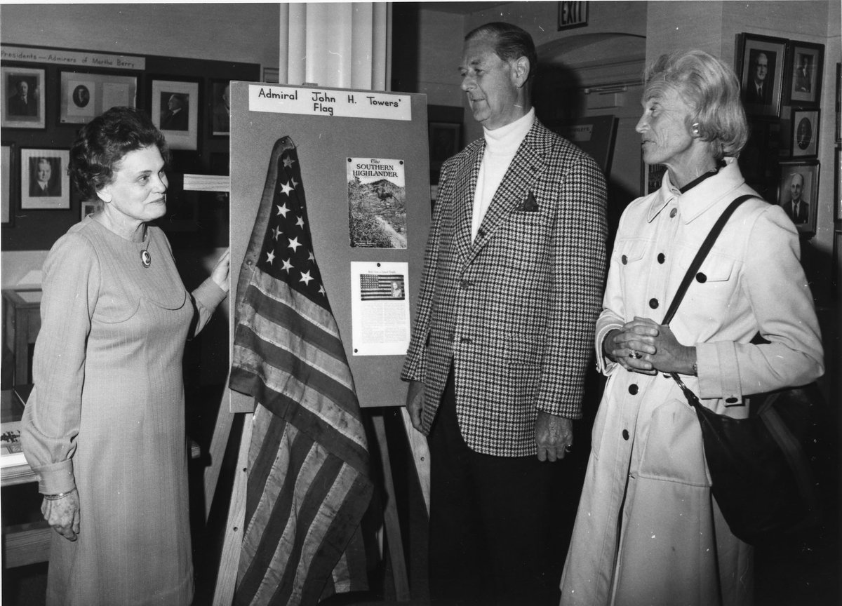 berrycollege's tweet photo. Dr. Inez Henry was the first director of @OakHillMuseum. Here, she shows guests the flag given to the schools by Admiral John H. Towers in 1918. This flag is the only known surviving flag of the first successful trans-Atlantic seaplane flight, which was lead by Towers. #TBT https://t.co/kJ2aeLw8ku
