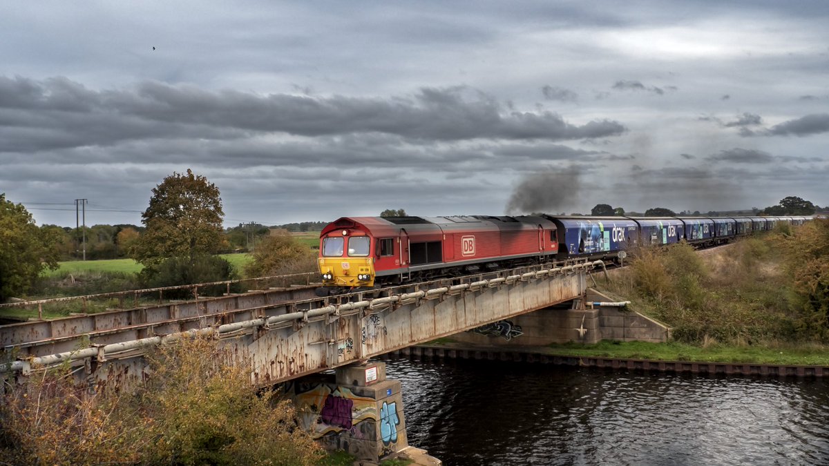 Shed Clag. DB Cargo 66128 crossing the River Don Navigation with a full load of Biomass for Drax Power Station. Barmby Dun 19/10/22
