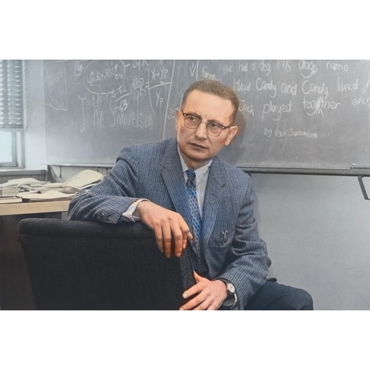 A colorized Paul Samuelson in his office, ca 1960-61. #MITeconomics. Scribblings on the blackboard of his son, John, are cute. irwincollier.com/colorised-econ…