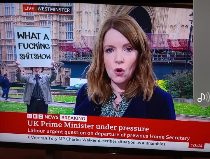 Who is holding that sign up do you think?