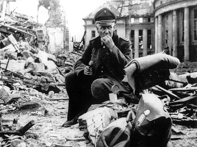 1945, Saarbrücken. Bir Alman askeri, muhtemelen ölmüş bir ABD askerinin konservesini yerken.