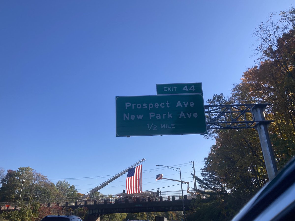 At I-84 overpasses from Farmington to East Hartford, firefighters and paramedics are displaying massive flags for this morning's funerals.