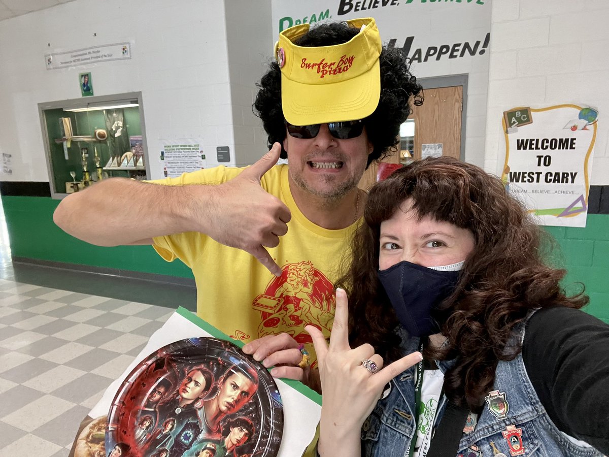 LangerMath's tweet photo. We ROCKED out the end of Spirit Week by transforming the 6th Grade Hallway into Hawkins Middle and brought Stranger Things to life! I made an appearance as Eddie Munson. The reaction from the kiddos was PRICELESS! 🥰🤟🏻🎸💚🤍🖤 @westcaryimps @wcpss @Stranger_Things #ImpFireClub https://t.co/REEgUIWUgP