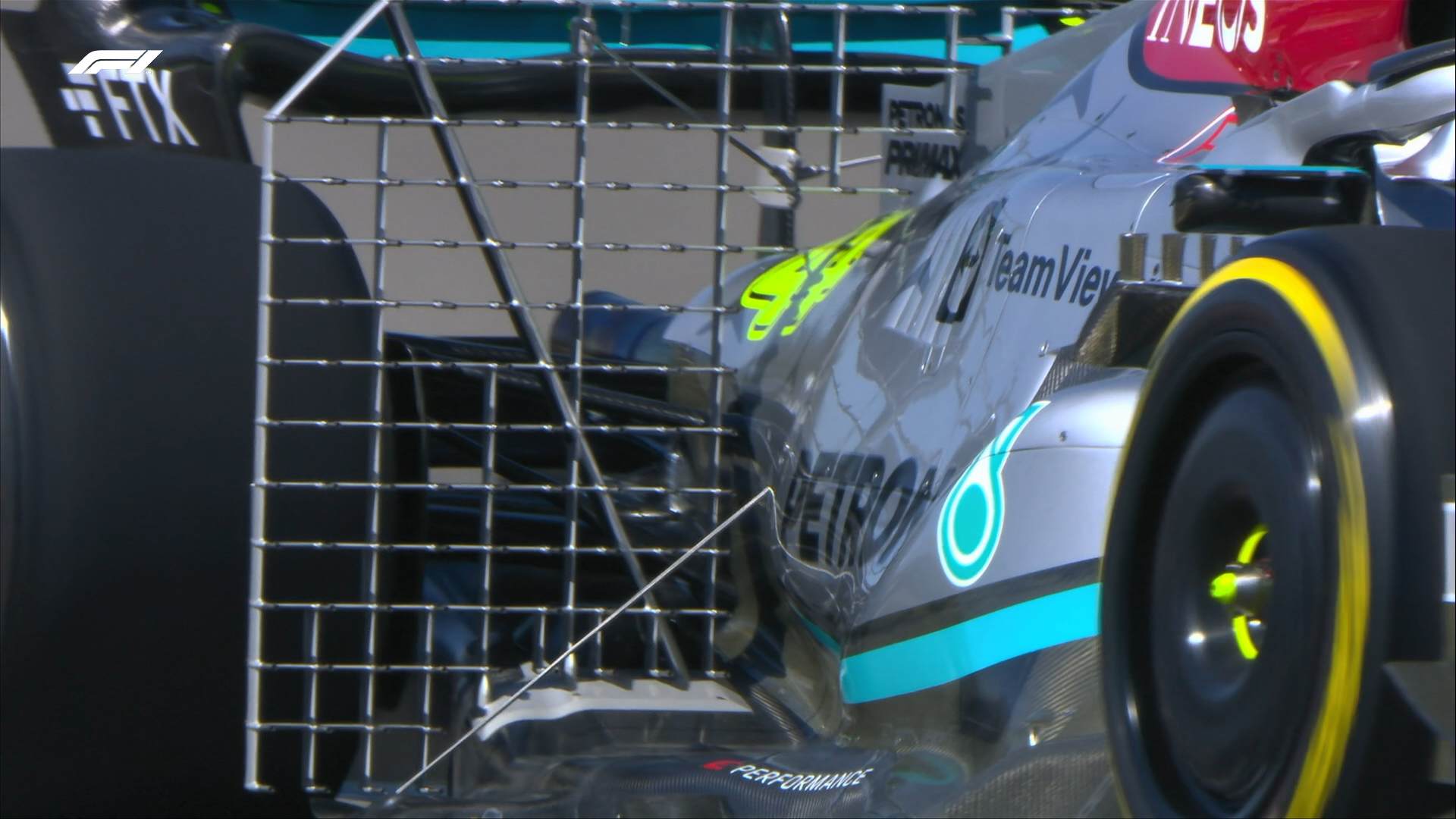 A close-up shot of the rear portion of Lewis Hamilton's car. A large, fence-like object can be seen running across the engine cover, parallel to the rear wing. This gridded, metal fixture is held in position and used to measure airflow over the car.