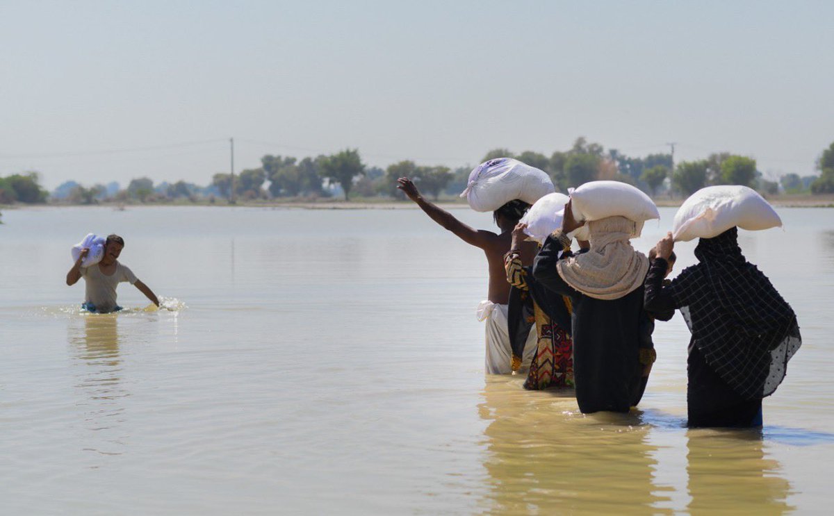 WCKitchen's tweet photo. WCK’s local Relief Team delivered food kits—filled with 6 weeks worth of food—to Johi &amp; nearby villages still underwater from historic floods in Pakistan. Electricity hasn’t returned in Ali’s village so he’s happy to also take candles back home with him. #ChefsForPakistan https://t.co/lnCD3EwVb5
