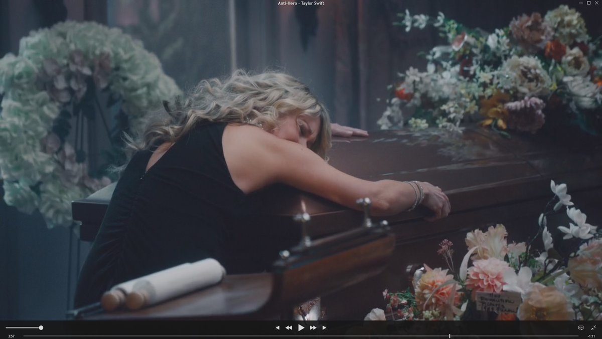 SandraHolst's tweet photo. I love the new @taylorswift13 album and video. So... I found something and can't help obsess over it. I can't find anyone mentioning the tiny note in the bouquet in the funeral scene of the #AntiHeroMV. Is this an actual encoded message? Am I overthinking it?🫣 https://t.co/iLbdybUdR3