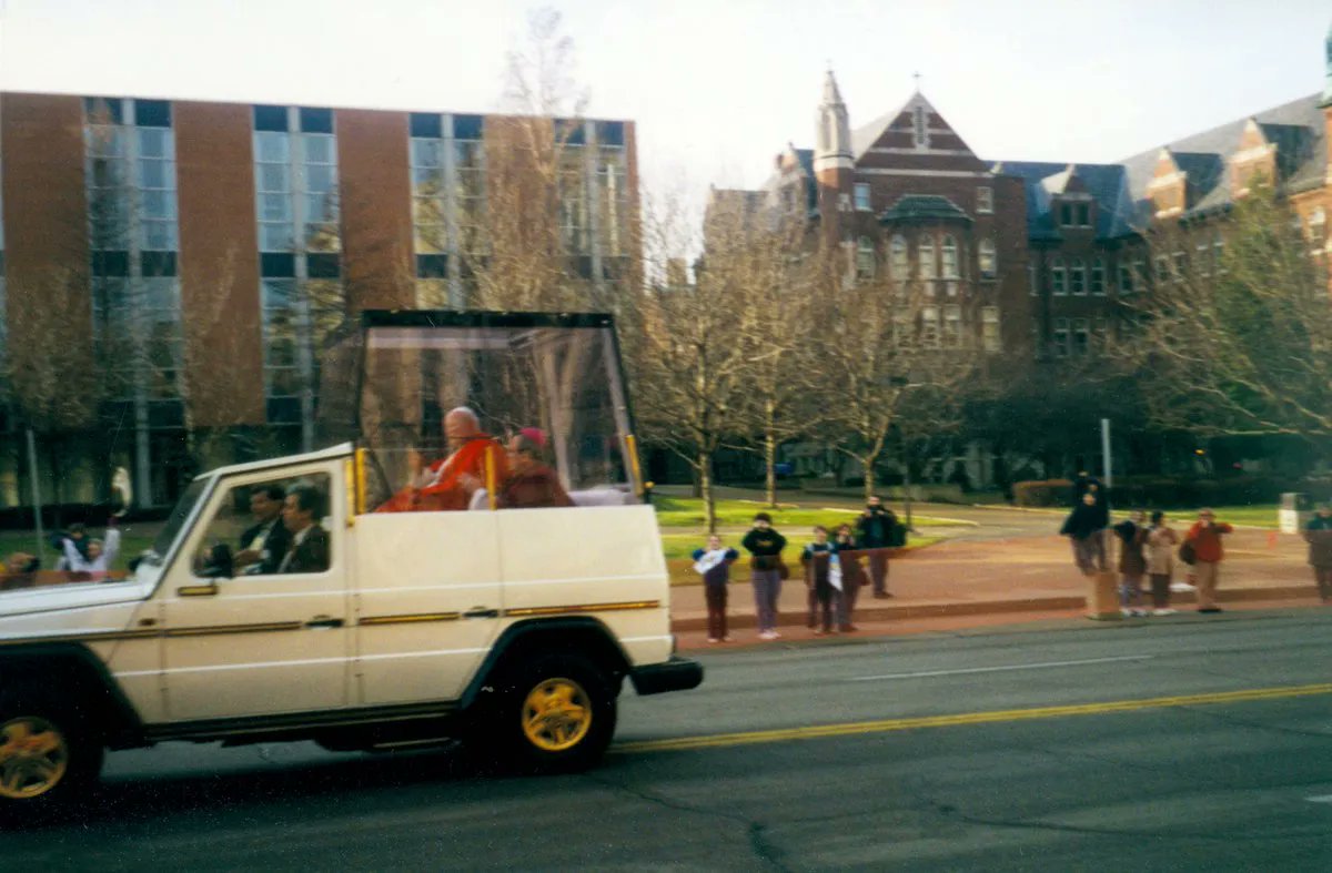 Happy feast of St. John Paul II, seen here driving past <a href="/piuslibrary/">Pius Library</a> in 1999, on his way to say Mass for over 100,000 people at the Dome.  #popemobile