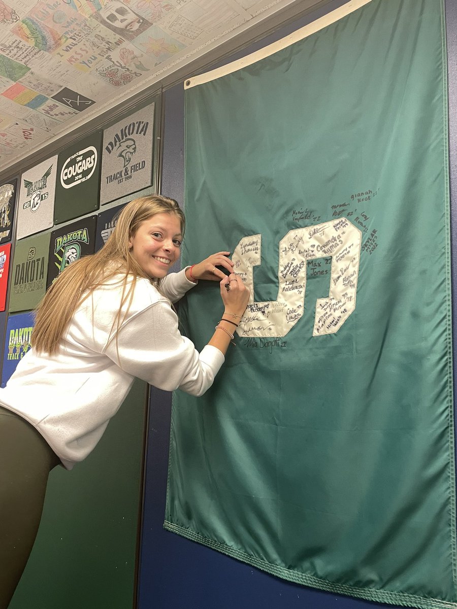 C/o ‘22 <a href="/DHSTrackField/">Dakota Track & Field</a>  alumni and current <a href="/michiganstateu/">MSU</a> Spartan, Kim adds her signature to my classroom flag! #SpartansWill