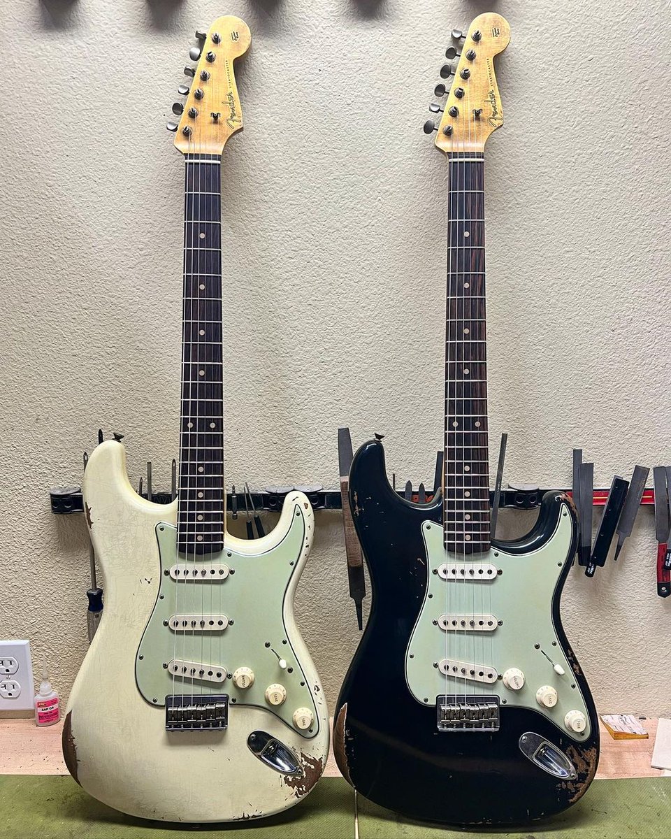 Fender's tweet photo. Celebrate #Straturday with this pair by Andy Hicks! These Vintage Black and White Strats feature a 7.25” radius with vintage upgrade frets, brazilian rosewood fingerboards and quartersawn maple necks. https://t.co/4JENg6r8J4
