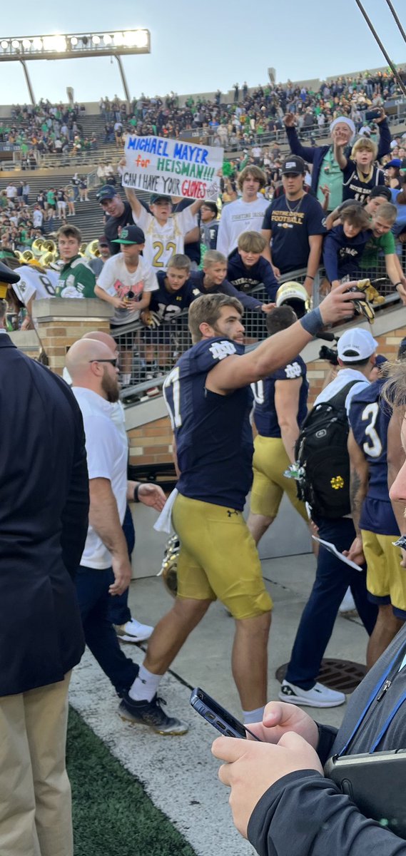 The kid with the sign didn’t get Michael Mayer’s gloves. But some other giddy youngster did. And you could tell it was an all-time moment for the fella. Michael Mayer: Good at football and a man of the people.