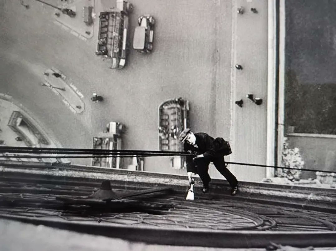 This is Mr Larkin, suspended on  a rope cleaning the clock face of Big Ben in March 1930.