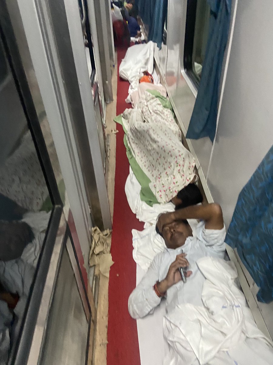 AadeshRide's tweet photo. @RailMinIndia @RailwayNorthern @rpfnr_ 
Travelling in 12556 and this is the scene outside my compartment for ac1
We can’t even use the washroom
The attendant is not helping and these people with no tickets amhave filled in the entire compartment.
No one to reach out to. https://t.co/J8s2etyEUk
