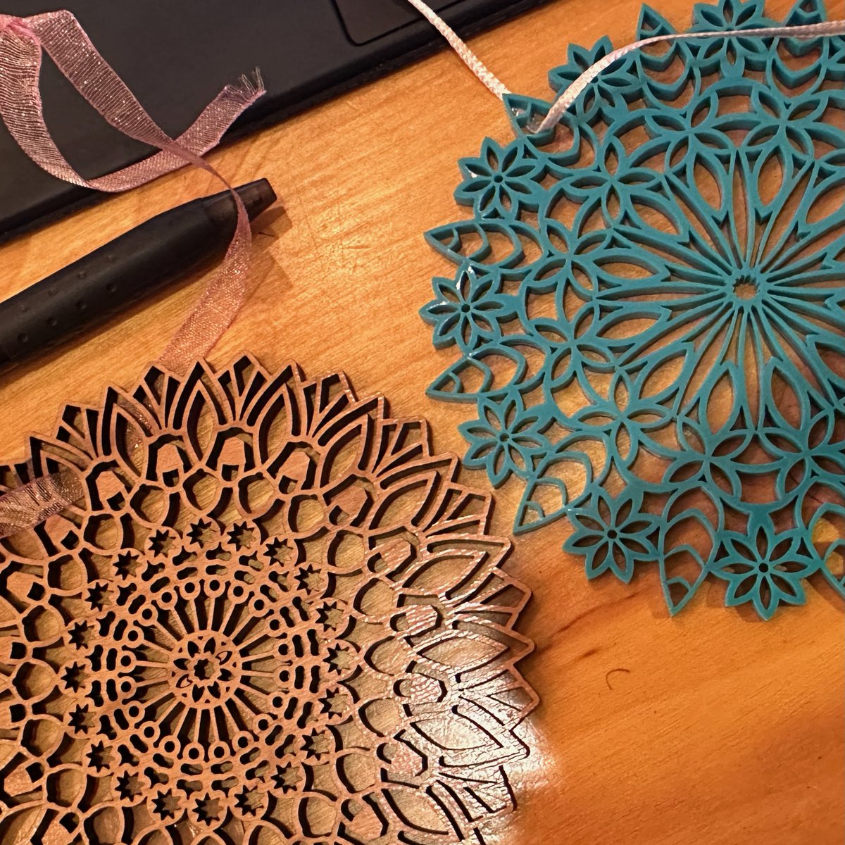 savage_smiling's tweet photo. Mandalas in cherry hardwood and blue acrylic https://t.co/Oz7Q3YgcH7