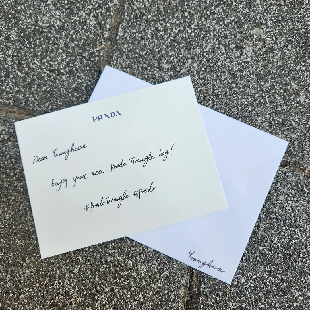 Youbghoon's tweet photo. With some trees in the back while they're still here (because we're entering autumn now), the photos turned out to be even much better than I expected. Thank you for sending me another triangle bag, dear Prada! You are always [chef's kiss] the best. 💛🖤 https://t.co/TqqgeCpFJa