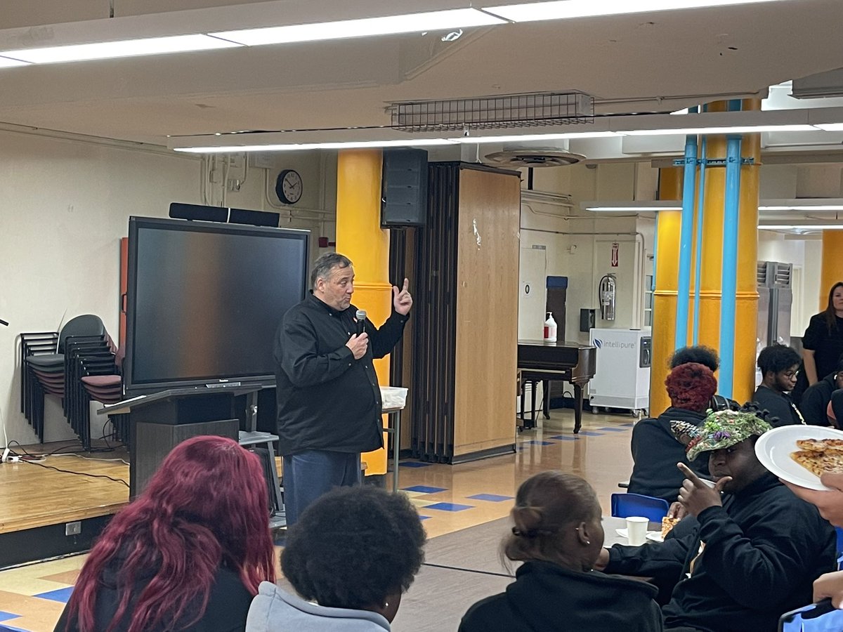 Harlem Renaissance Principal Caputo celebrating students on the honor roll and improved attendance