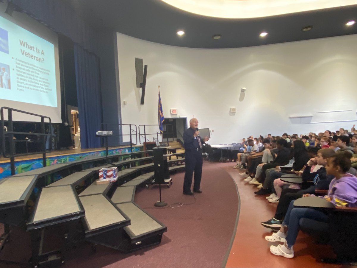 Dever students grades 3-6 learn about Veterans Day at an assembly led by George Catalanotto
