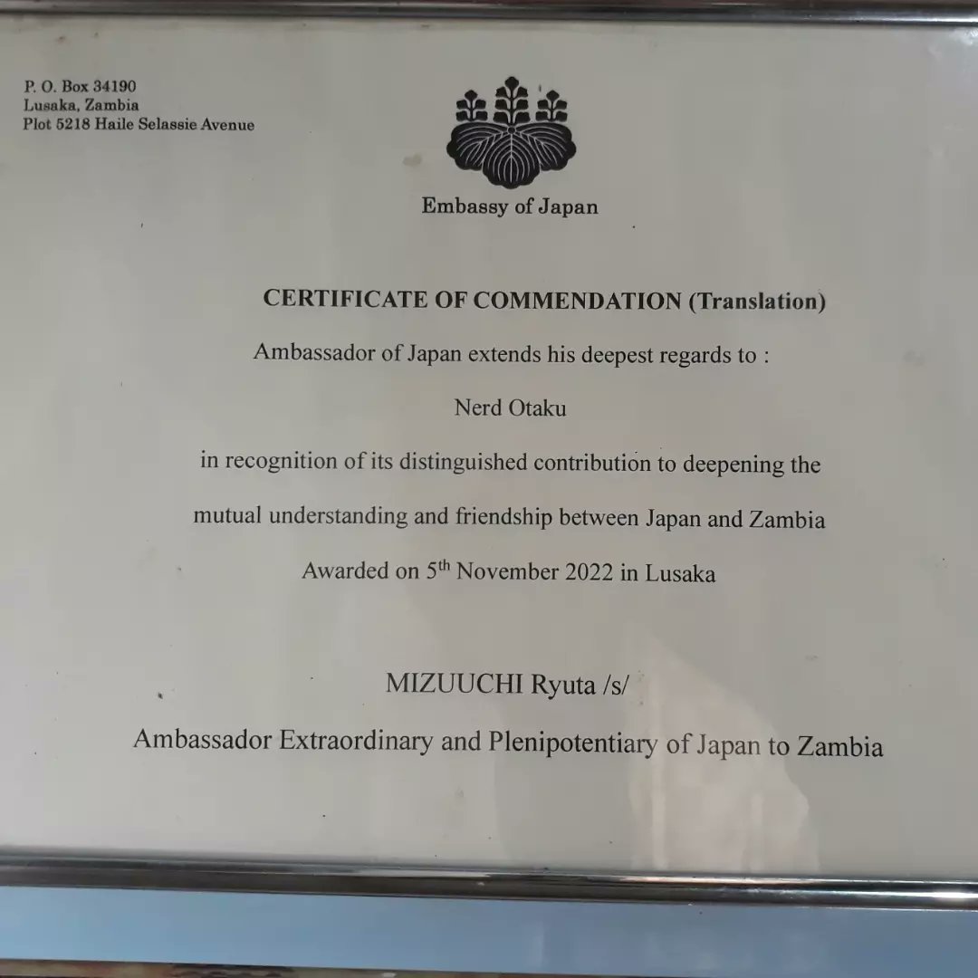 kiddtic's tweet photo. Yesterday at #LsCon2022 The Japanese Ambassador honoured @NerDOtakUzm with a Certificate of Commendation. This one is for the whole team! And I made sure to let them know that this one is theirs for all their hard work and resilience. https://t.co/JA2878OPDW