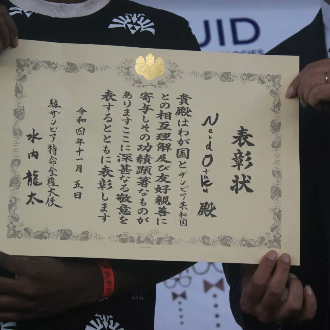 kiddtic's tweet photo. Yesterday at #LsCon2022 The Japanese Ambassador honoured @NerDOtakUzm with a Certificate of Commendation. This one is for the whole team! And I made sure to let them know that this one is theirs for all their hard work and resilience. https://t.co/JA2878OPDW