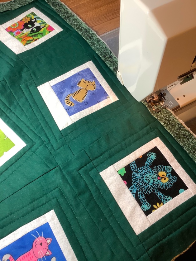 Binding the Polaroid cat quilt. Once the binding is machine stitched in place, then I can finally begin hand sewing it. #quilt #quilting #Cat #Caturday