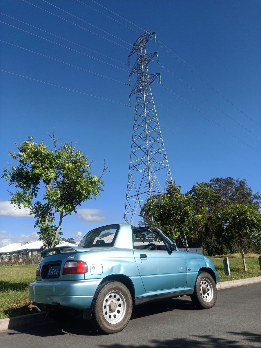 Classic_Clunker's tweet photo. Different day, different car under a different power pole. Same good morning. Plus, what might be the biggest garden hose I've ever seen. T-tops left in the garage. #Suzuki #X90 #ttops https://t.co/hfpM6FnonX