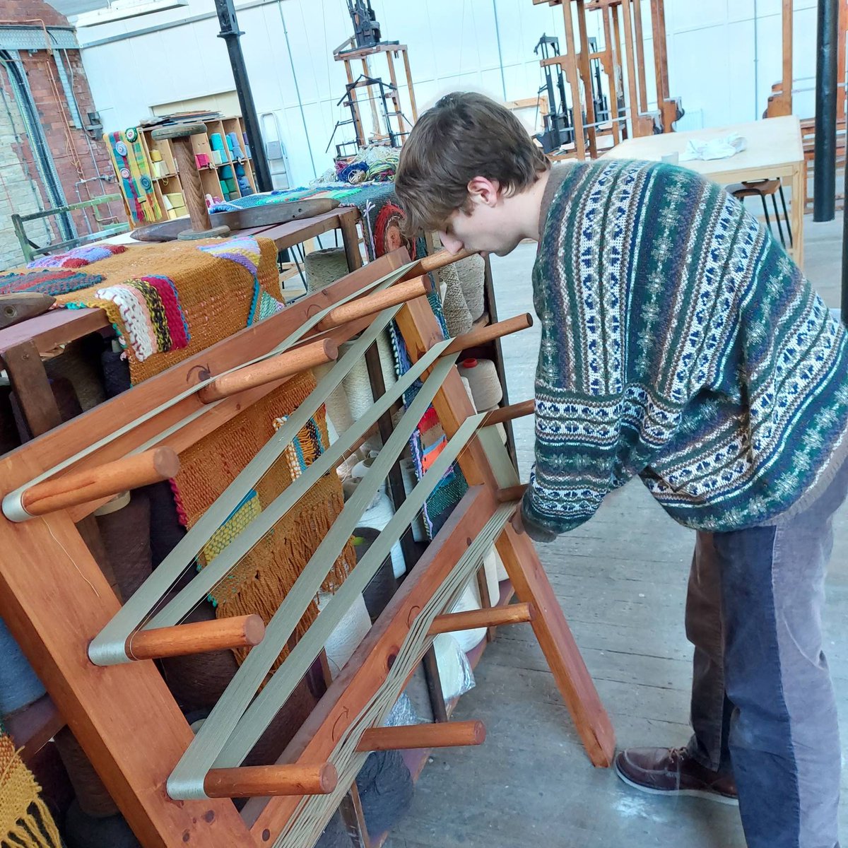 sunnybankmills's tweet photo. Today David @foxonthesley, is warping his loom. David is a Textile Design student at Leeds Uni on his Placement year here in the Archive. He's been researching our Guard Books and will be reinventing some of the designs & history he has found. #LifeAtTheLoom #MillLIfe https://t.co/M1vBrp41rX