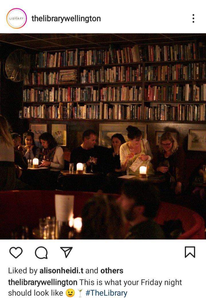IG account for the Library Wellington. Image of the inside of the bar, dim candlelight, shelves of books