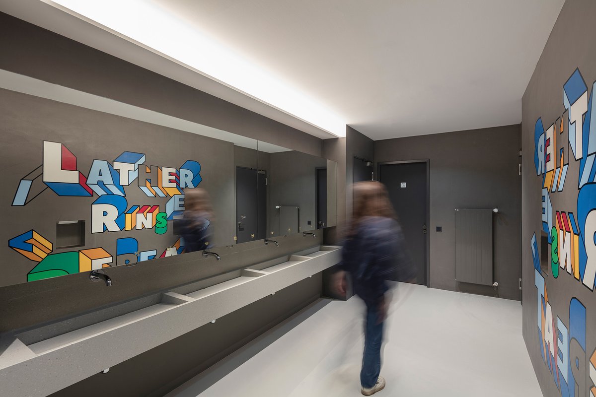 Custom communal wash basin with a splash of fun.

In our <a href="/contentful/">Contentful</a> Berlin workplace project, sink material by <a href="/coriandesign/">Corian Design</a>, flooring by Sensoflooring, mural by @StartlingBrands .

Photography: Koy + Winkel