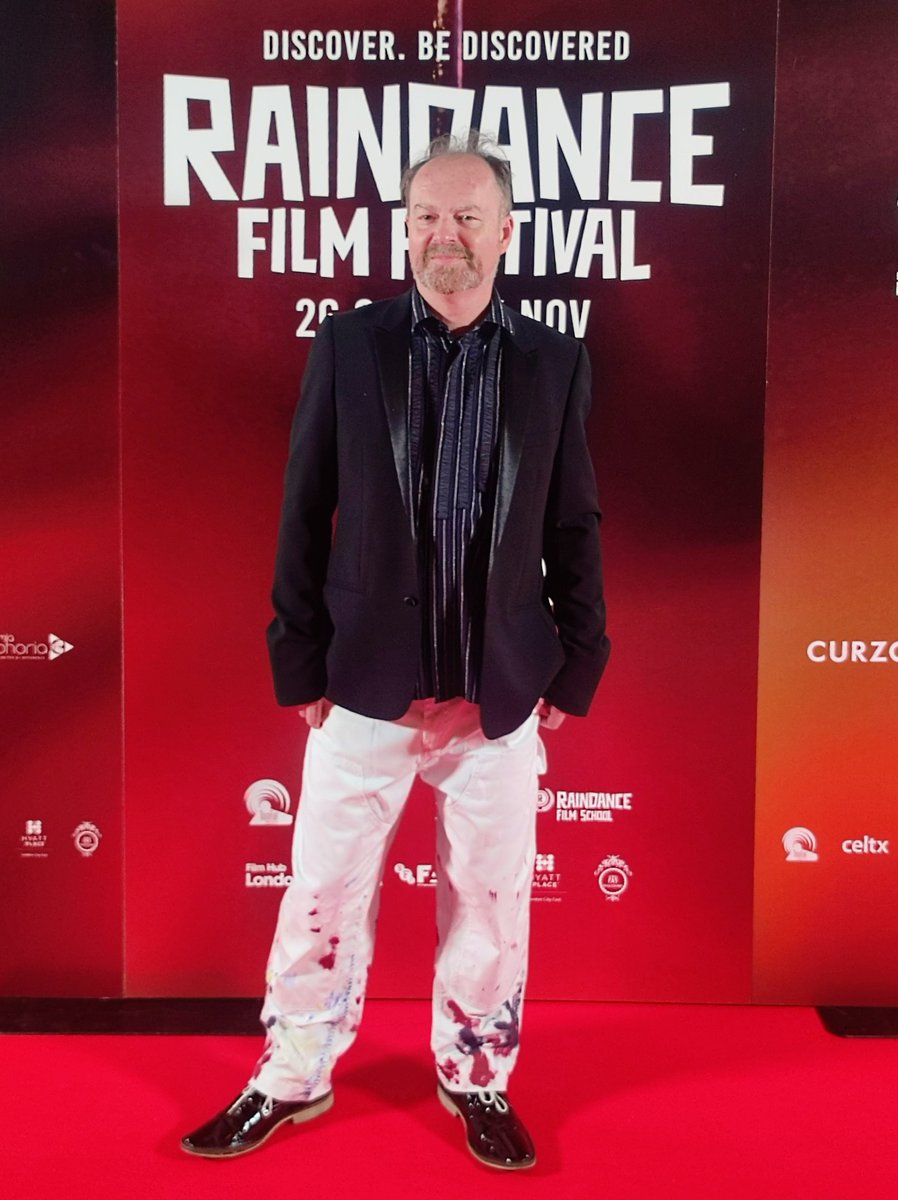 workofstuart's tweet photo. A quiet moment on the red carpet, just before the start of the opening gala of the 30th @Raindance - wearing painted carpenter trousers by LC23 and DJ by All Saints https://t.co/dTzMA5hvzc