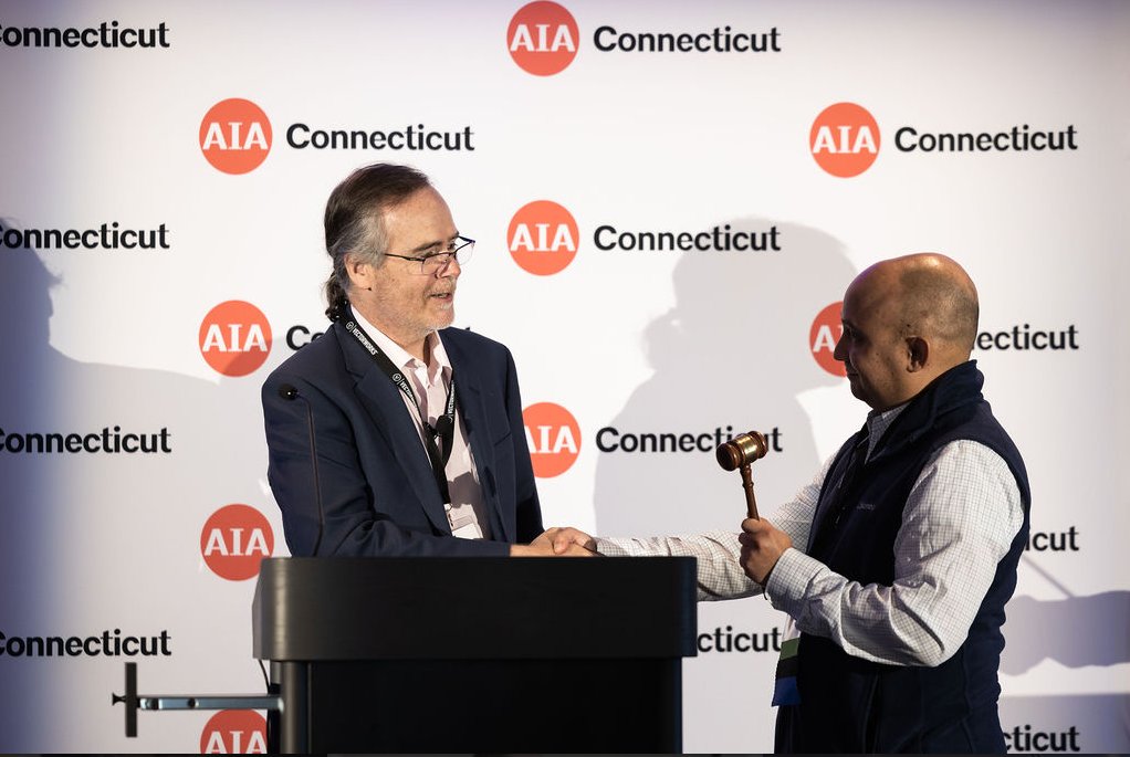 Principal, <a href="/PaoloCampos/">Thought Crime</a> of #PatriquinArchitects receives the gavel, officially stepping in as AIA CT 2022-2023 Chapter President at #AIACT 's #CACX'22.