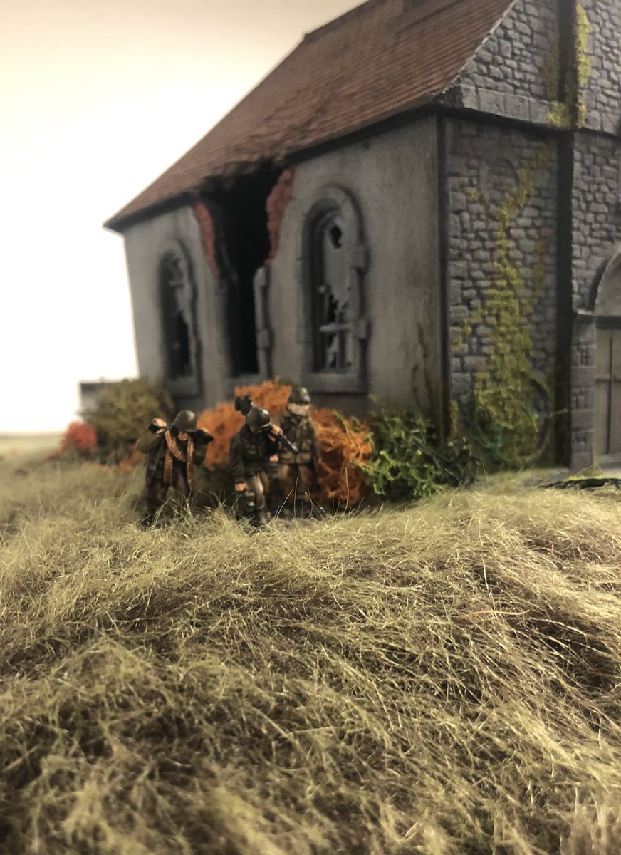 American .30 cal team trudges past the church