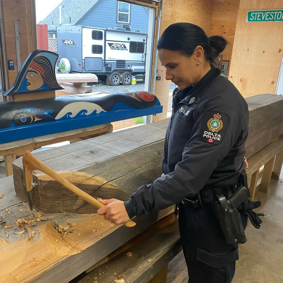Cst Glen learning how to carve a host post under the tutelage of Karl Morgan
