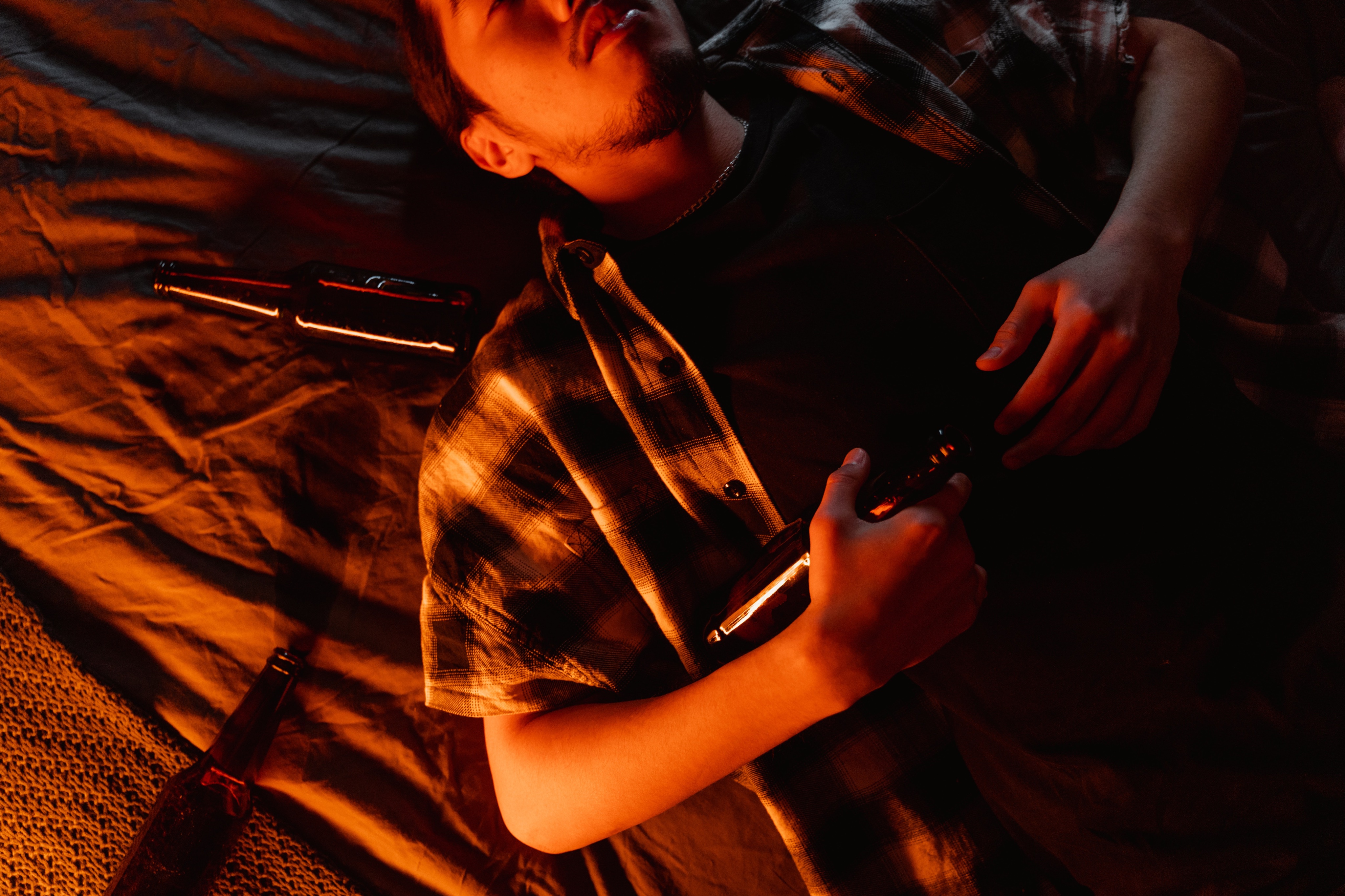 A drunk man sleeping in bed 