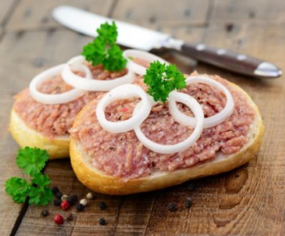 Mettbrötchen is a Northern German breakfast sandwich of mett (minced and seasoned raw pork) on a roll

It's called zwiebelmett, if the sandwich comes with raw onion
