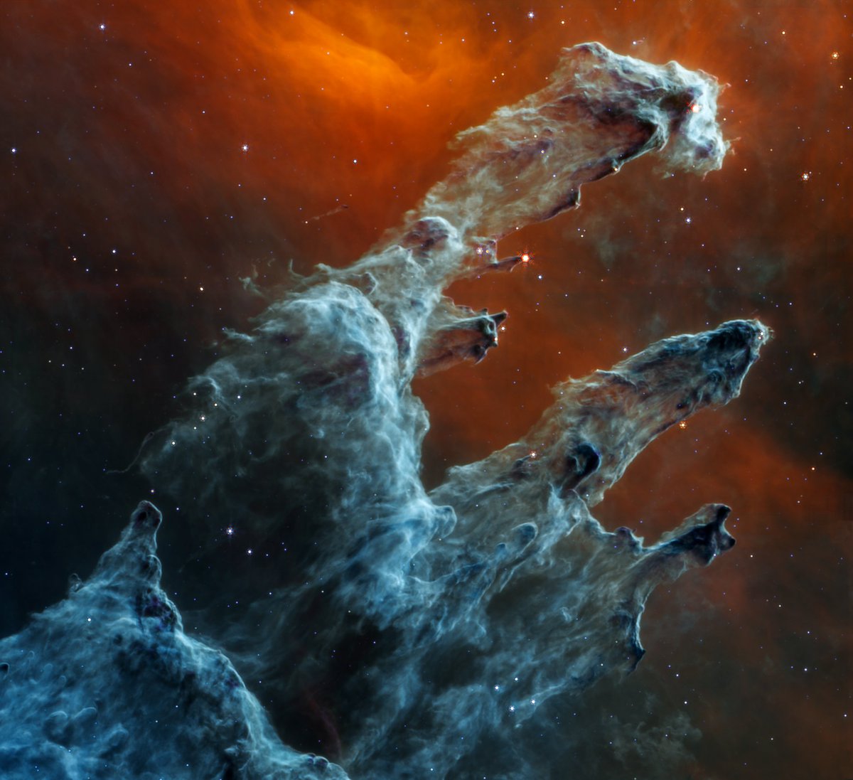 When the Pillars of Creation reach out to drag a dusty fingernail down your spine. This view from <a href="/NASAWebb/">NASA Webb Telescope</a> shows the ancient cloaks of dust in new detail. Hidden within are baby stars, peeking out from the edges as bright orange dots: go.nasa.gov/3DGI2ws