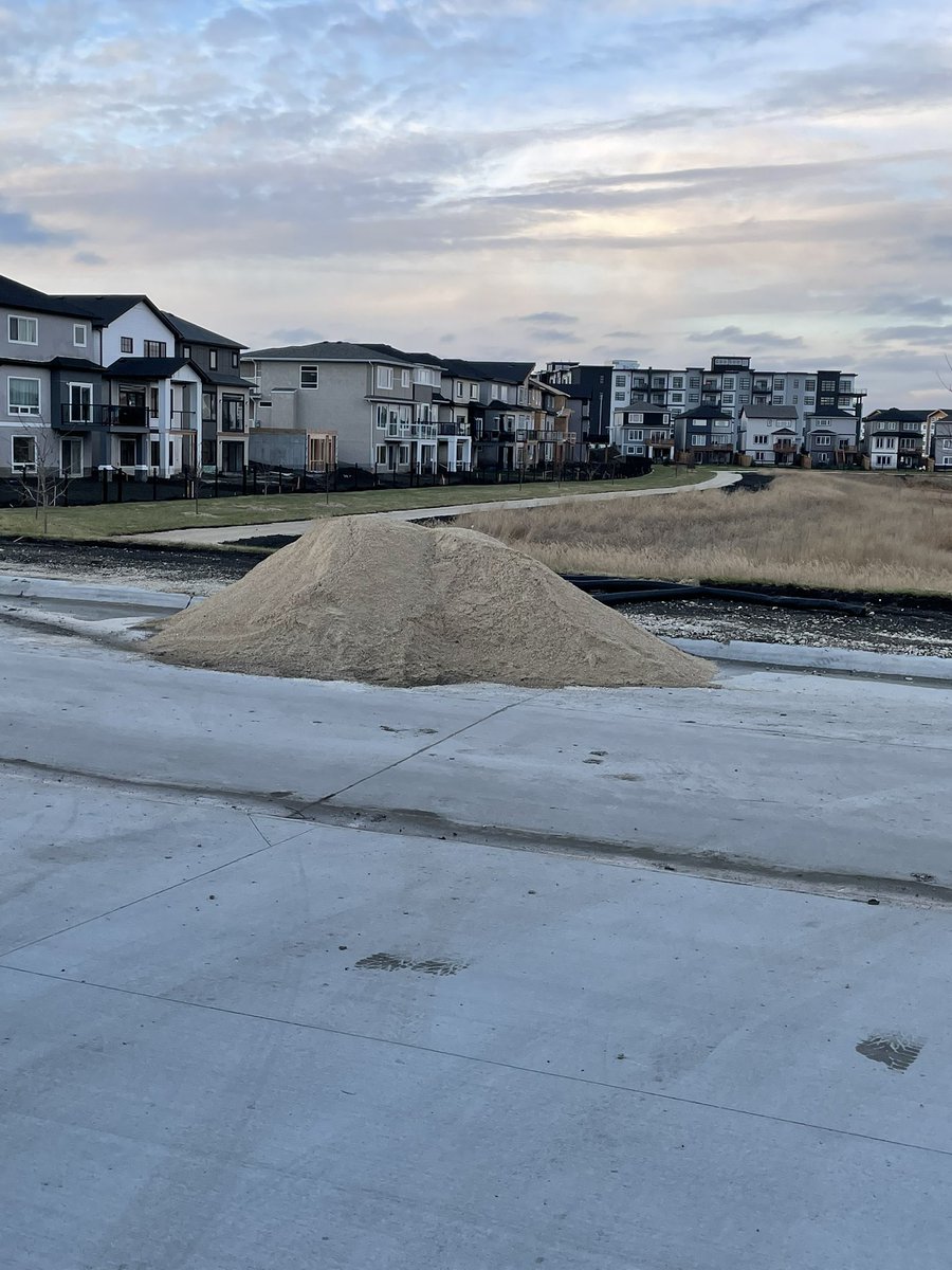 VisserJessica's tweet photo. @cityofwinnipeg there has been a gravel pile blocking one lane of our street for weeks. There are no flags or markers and people keep hitting it with their cars. Can you do something about it?? https://t.co/OFwW8jzDhf