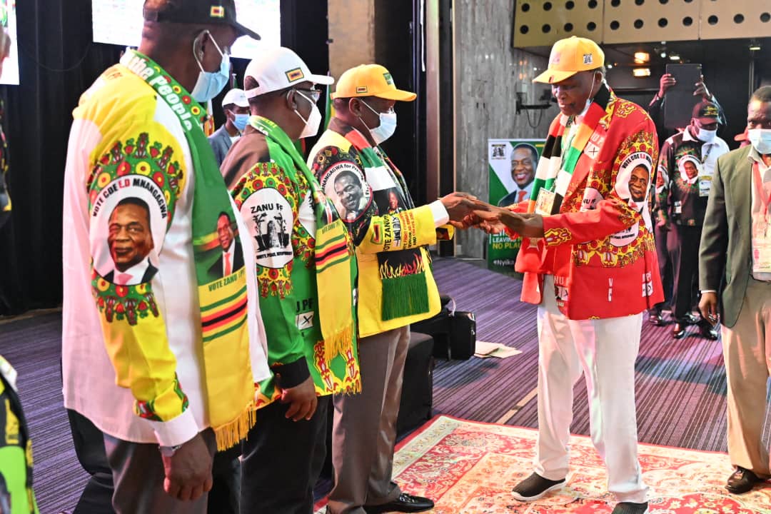 HE hands over certificates of achievement to outgoing members of the disolved Central Committee. JD Hungwe of Masvingo Province receives his.