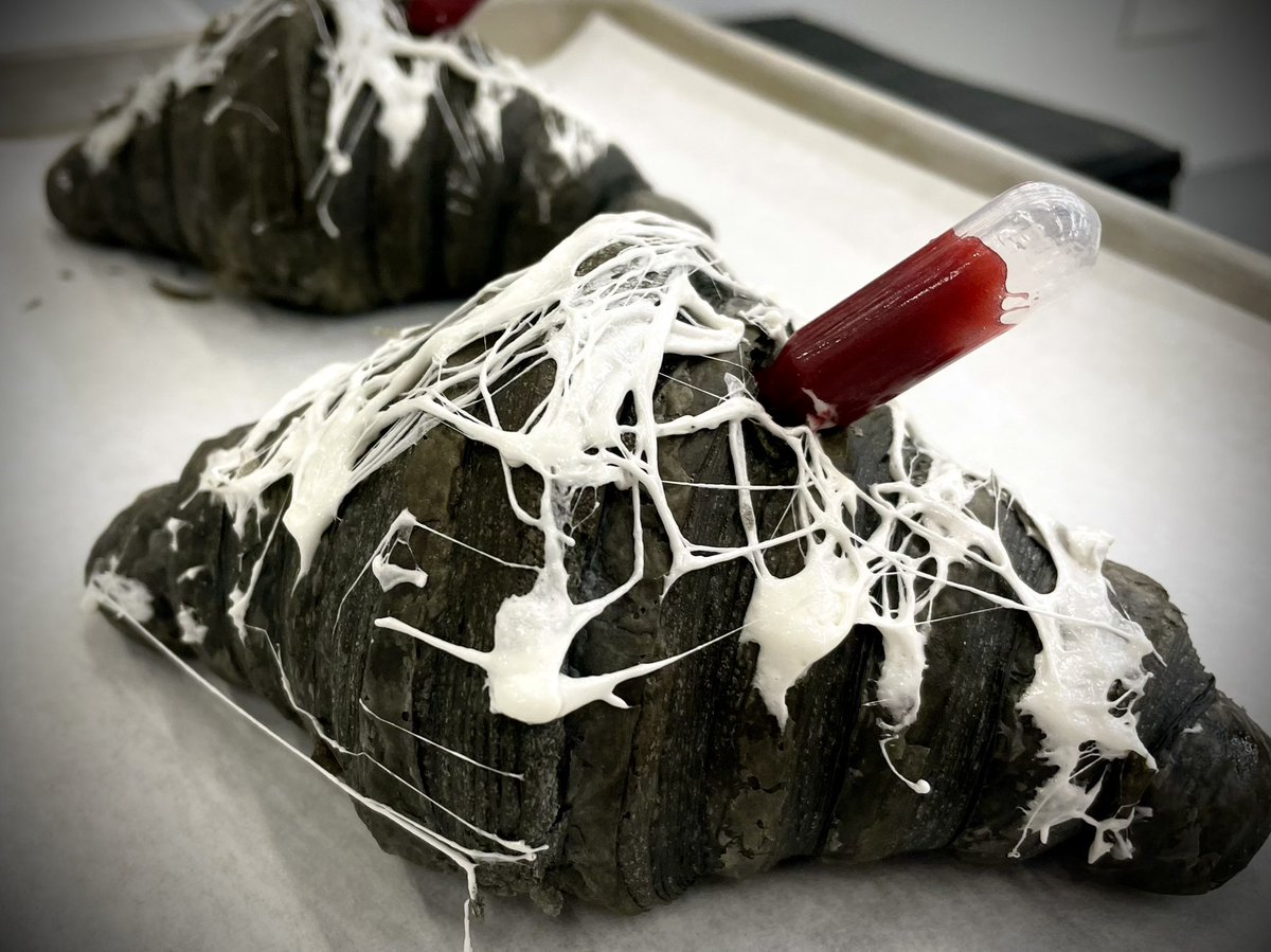 SparrowCoffee's tweet photo. Our black #croissant special for #Halloween weekend, Fri-Sun only. #Vanilla bean cream & #raspberry coulis. Spooky spider webs (melted #marshmallow) & a blood vial (extra coulis for more scariness). Offered until we sell out each day. #Naperville #coffee #muahahah https://t.co/1oEWMTBGsm