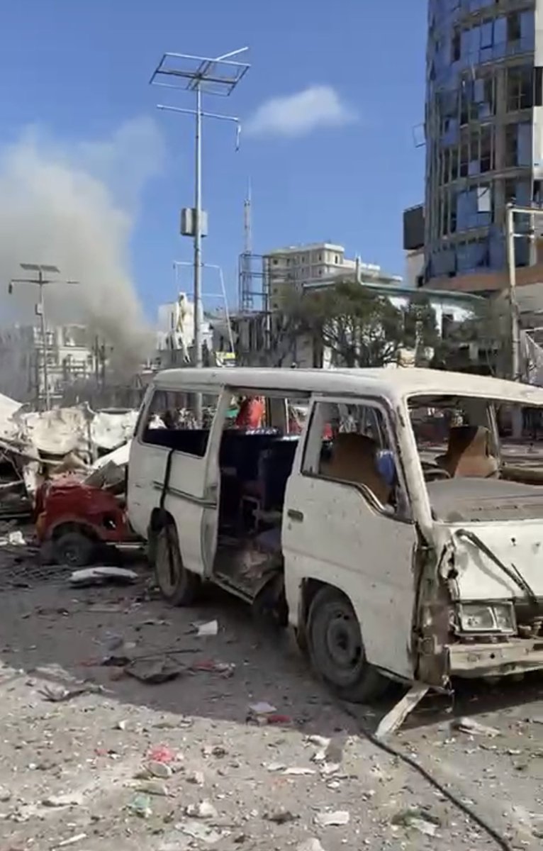 HarunMaruf's tweet photo. Witness video from the scene of the bombing shows dead and wounded lying on the ground; massive destruction to the buildings around Zobe junction and the ministry of education. #Mogadishu https://t.co/V6aQj04VWv