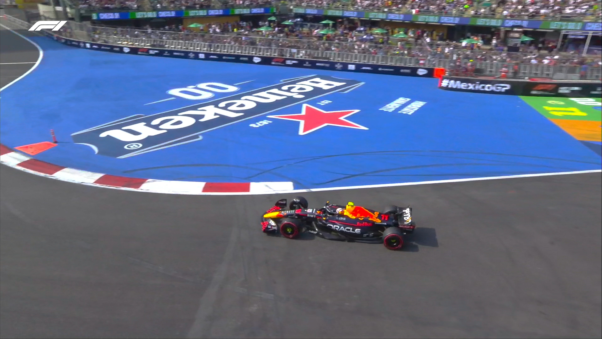 A side-on shot from above of Sergio Perez's Red Bull Racing car as he goes through the stadium section