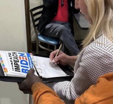 JaneotN's tweet photo. Nothing to see here, folks. Just Marjorie Taylor Greene signing autographs as “Speaker of the House” right before Nancy Pelosi’s husband was attacked. https://t.co/yjI9vrOW5M