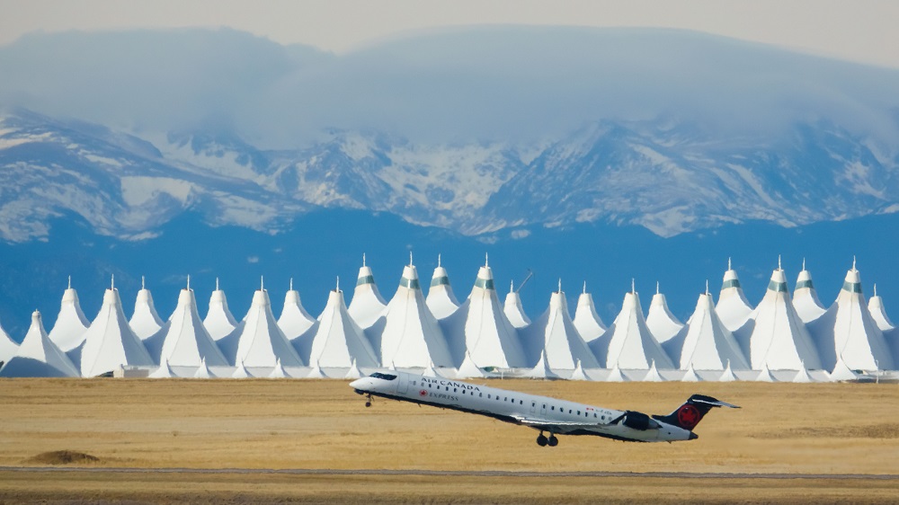 DENAirport's tweet photo. Today marks 27 years of @AirCanada serving Denver! You can spot their aircraft at DEN from the red maple leaf on their tail, just as is pictured. Enjoy service to Toronto, Montreal and Vancouver. 🇨🇦 #FlyDEN https://t.co/mv2v0ljxI9